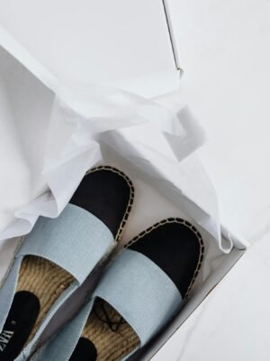 Elegant espadrilles in a box, showcasing fashion-forward style and online purchase convenience.